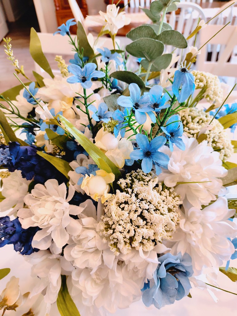 Blue, white, and beige faux floral arrangement.
acrossthelake.blog