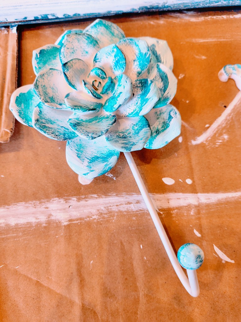 Painting a white plaster rose hanger teal and white.
acrossthelake.blog