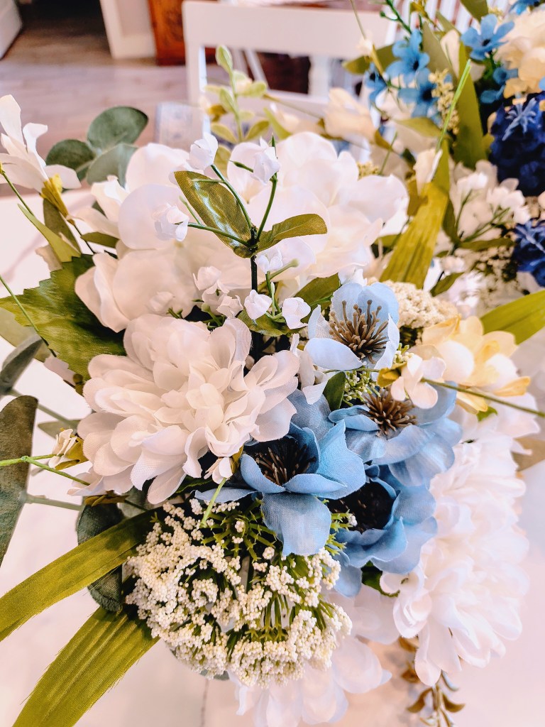 Faux floral arrangement in white, beige, and blue.
acrossthelake.blog
