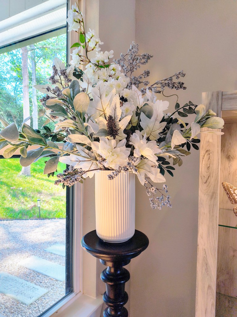 Large faux floral arrangement in white, green, and frosted lavender.
acrossthelake.blog