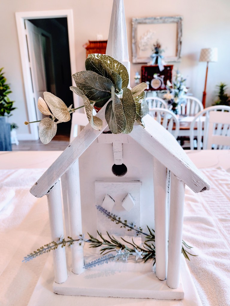 Vintage white church birdhouse with fresh paint and faux florals.
acrossthelake.blog