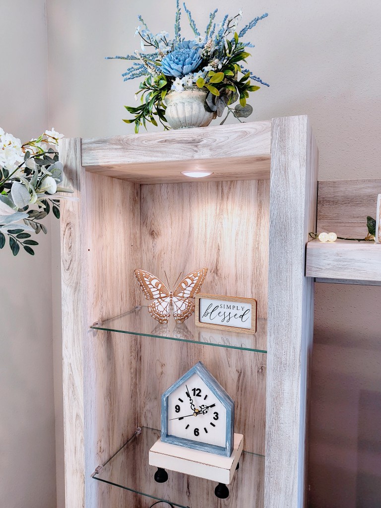Entertainment center decor.  French country home style.  After photo of house style clock.
acrossthelake.blog