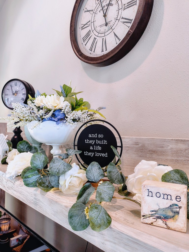 Above entertainment center focal point decor.  Vintage style French country home decor.
acrossthelake.blog