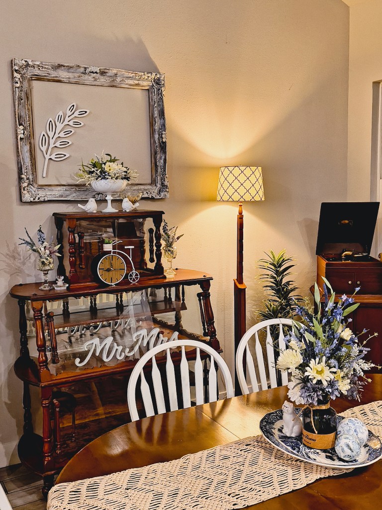 Dining room decor including antiques and salvaged wooden frame.
acrossthelake.blog