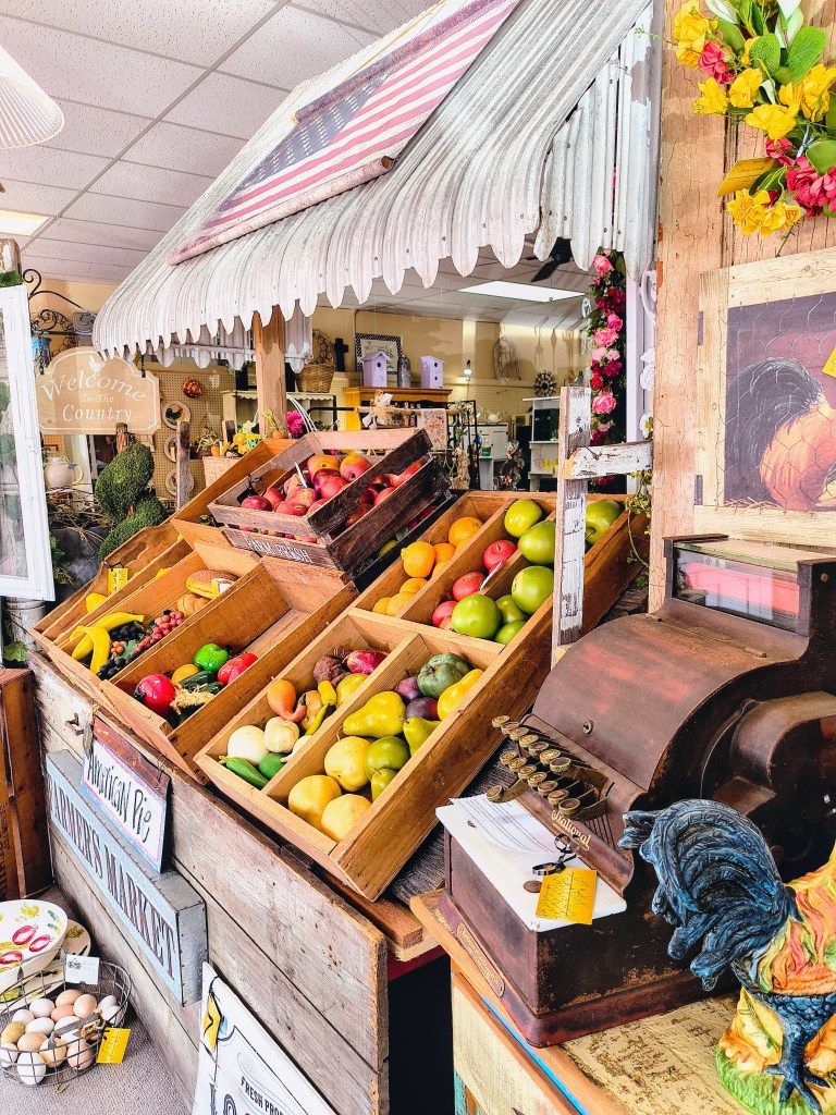 Farmers Market window display at Mimi's on Main in Conroe, TX.
acrossthelake.blog