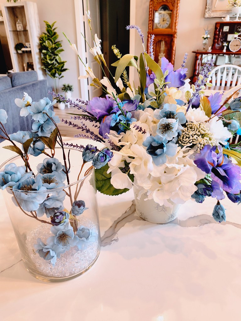 Blue, purple, and white faux floral arrangements.
acrossthelake.blog