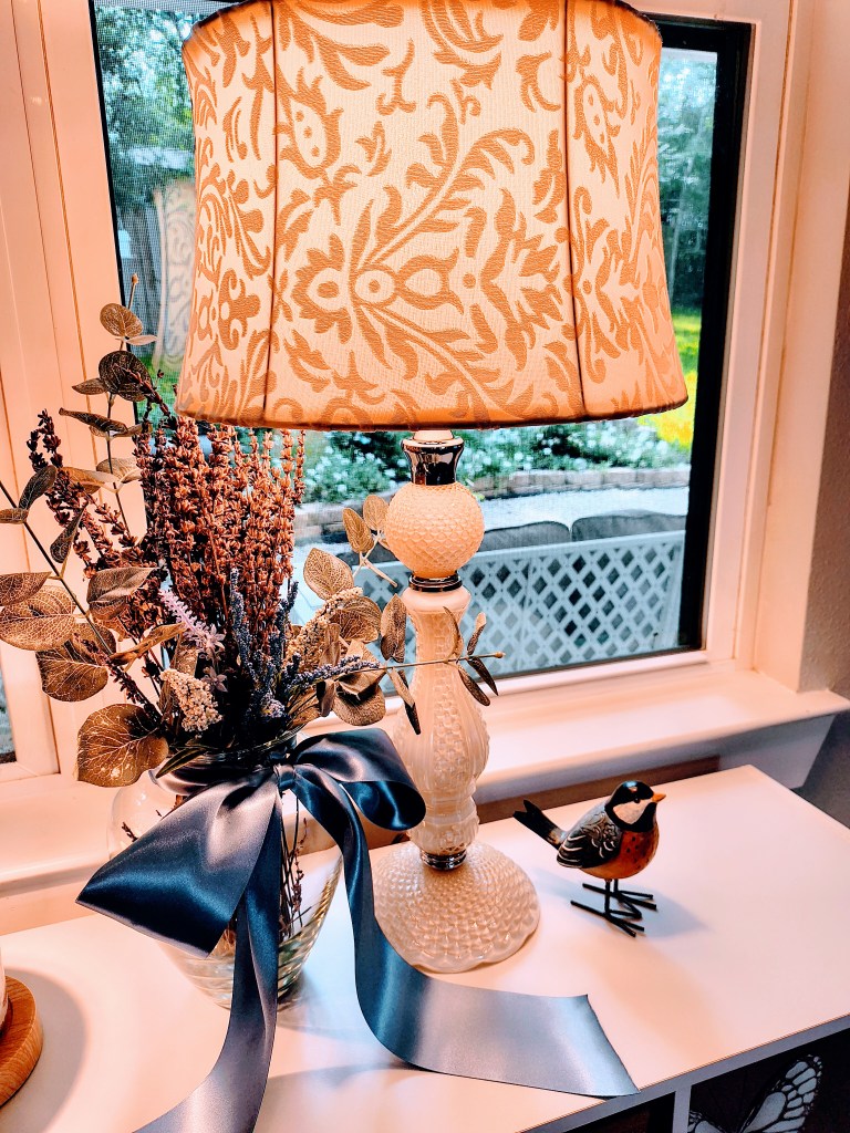 Cream colored glass vintage style lamp.
acrossthelake.blog